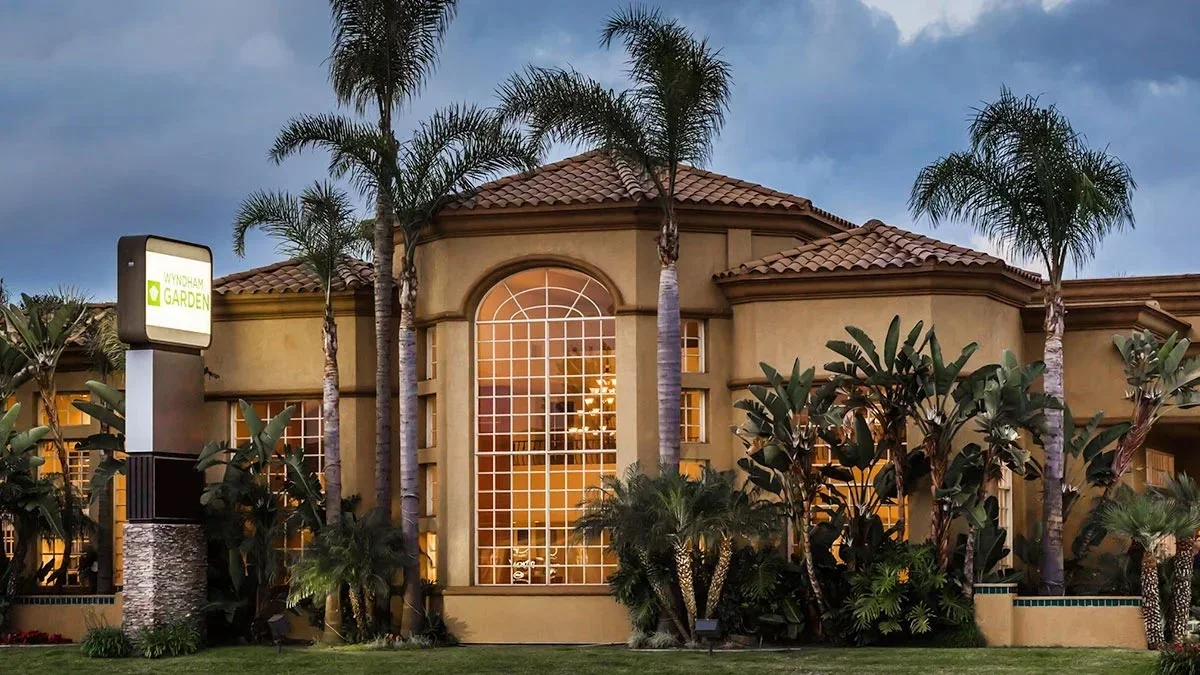 Exterior of the Wyndham Garden San Diego surrounded by palm trees - San Diego, California, USA